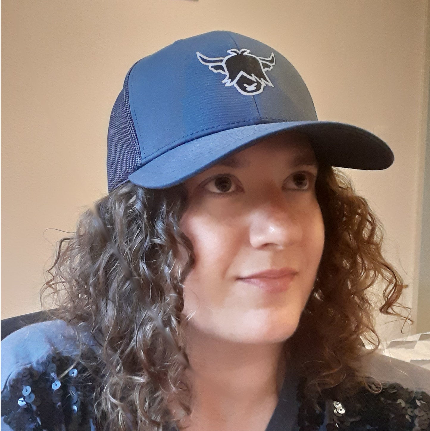 woman wearing a highland cow trucker cap