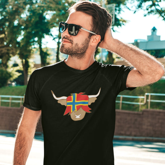 man wearing a black t-shirt with a flag of orkney on a highland cow