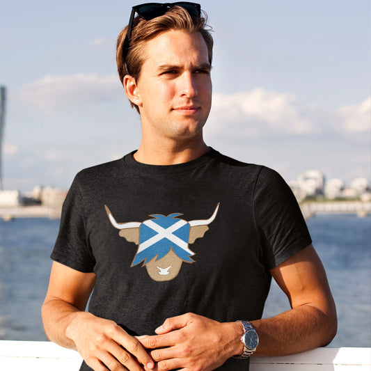 man wearing black highland cow tshirt with scottish flag