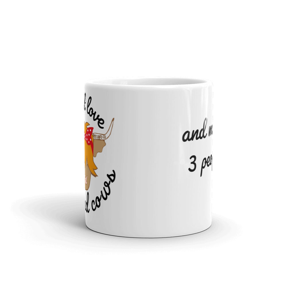 11 oz white ceramic mug with the design of a highland cow and the statement i just love highland cows and maybe three people - frontal view