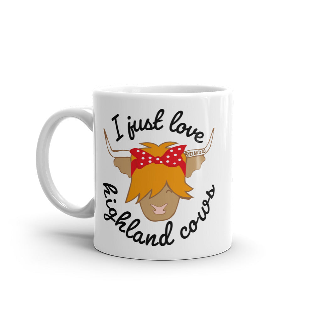 11 oz white ceramic mug with the design of a highland cow and the statement i just love highland cows and maybe three people - side 1