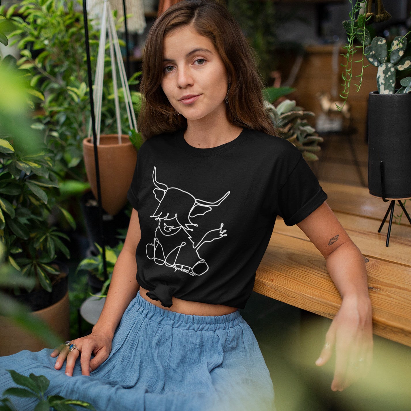 woman wearing a cow line art design tshirt
