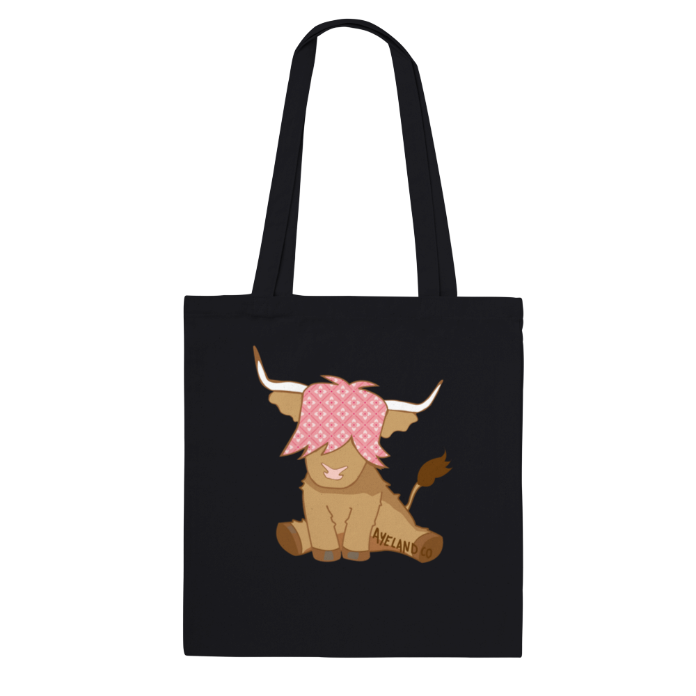 pink highland cow design on a black cotton tote bag